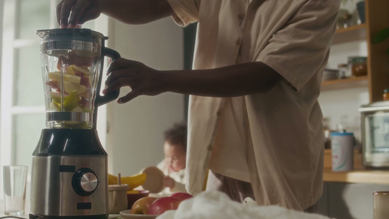 Father Blending Fresh Fruit Smoothie in Kitchen