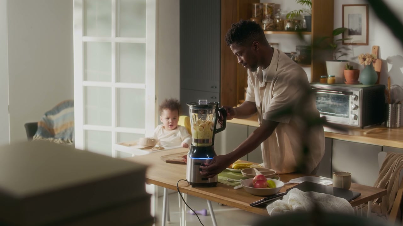 Father Blends Healthy Baby Food in Kitchen