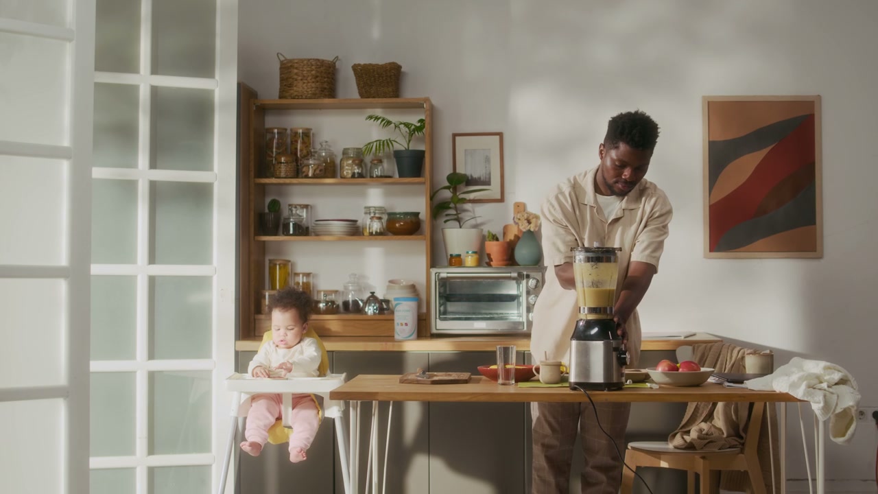 Father Making Smoothie for Baby in Kitchen