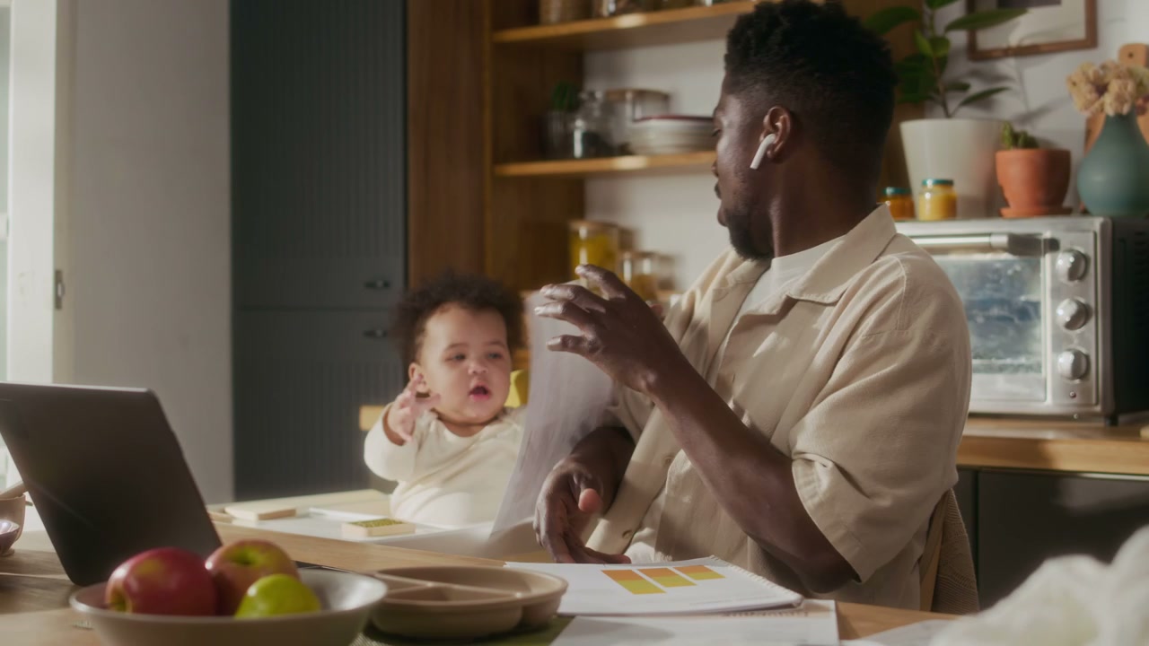 Black Father Working From Home With Baby