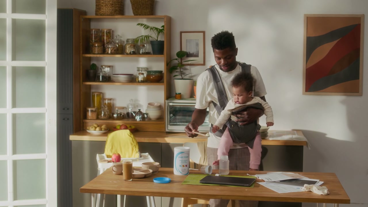 Father Preparing Baby Formula in Kitchen