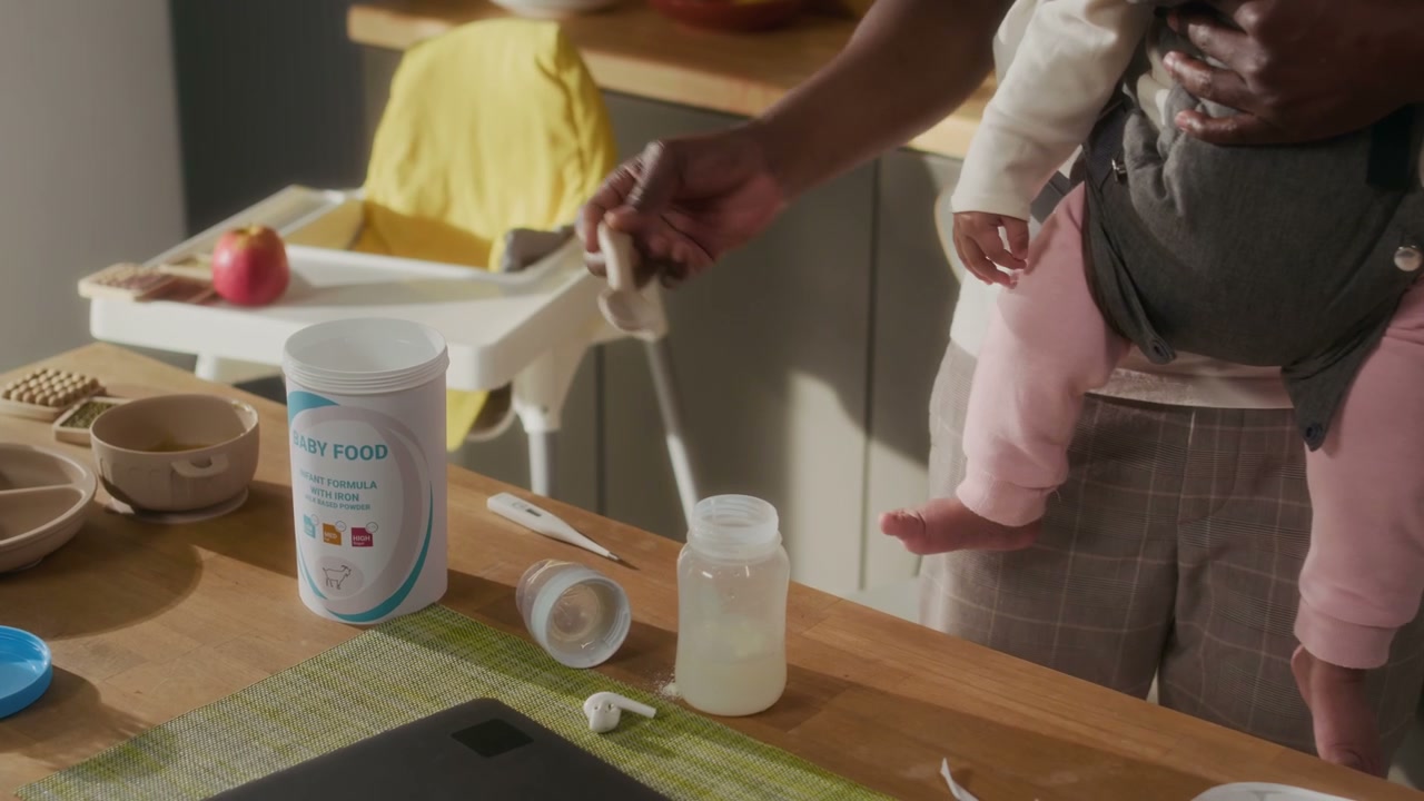 Dad Preparing Baby Formula in Kitchen with Child