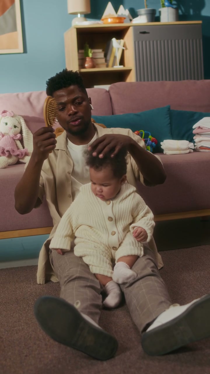 Father Brushing Baby's Hair