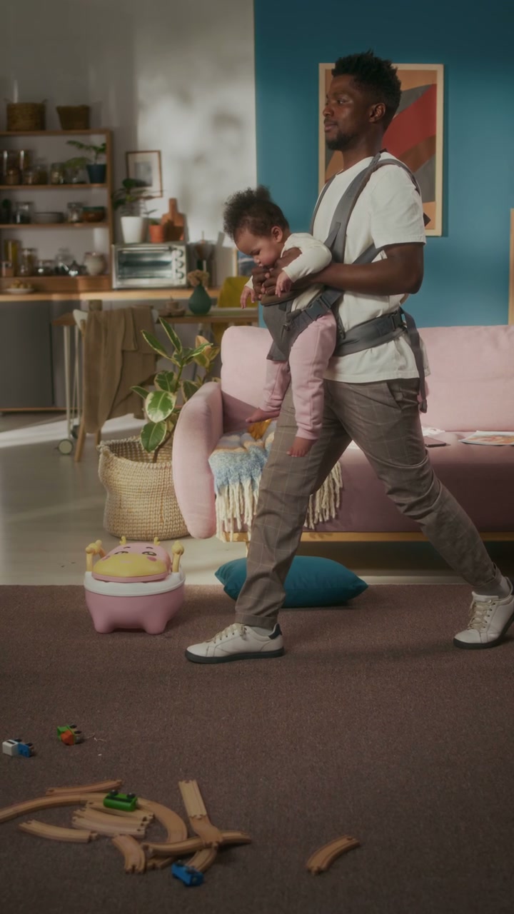 Father Doing Lunges with Baby in Carrier at Home