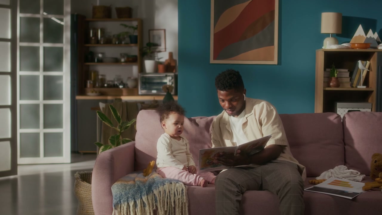 Dad Reading Picture Book to Baby