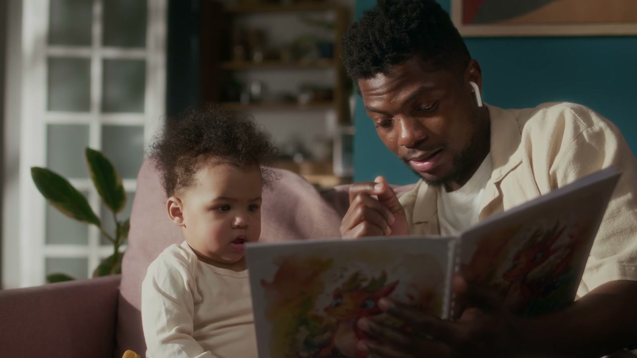 Father Reading Storybook to Baby Daughter