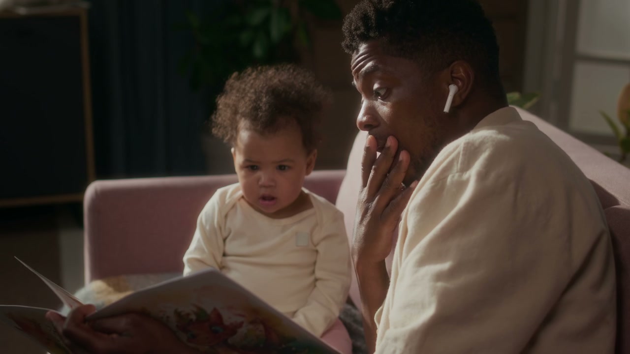 Father Reading Storybook to Baby