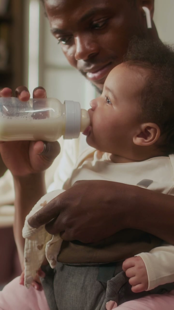 Black Father Feeding Baby with Bottle