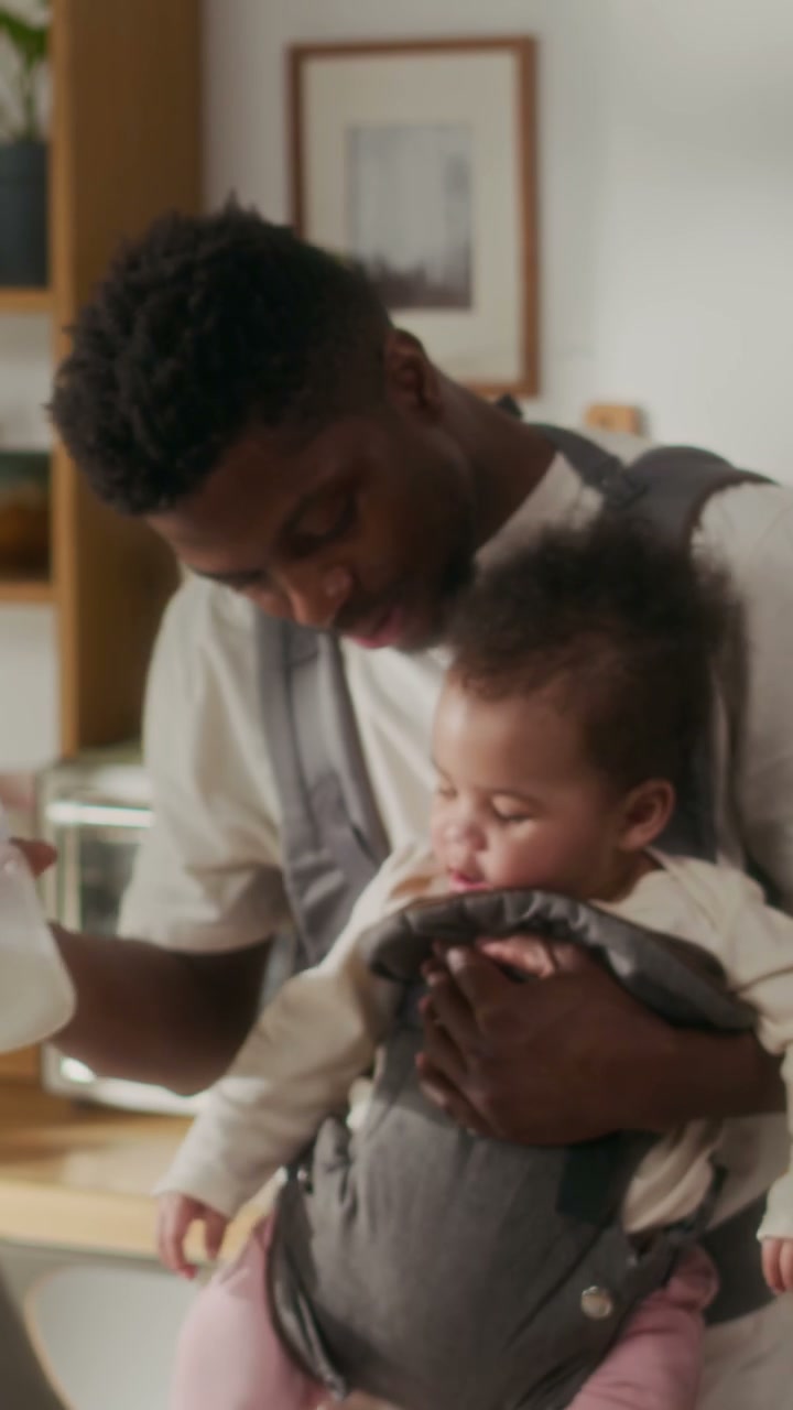Father Prepares Baby Bottle in Kitchen