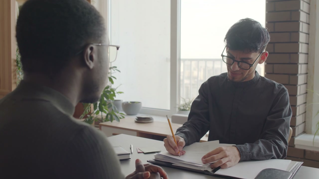 Men Interviewing and Taking Notes