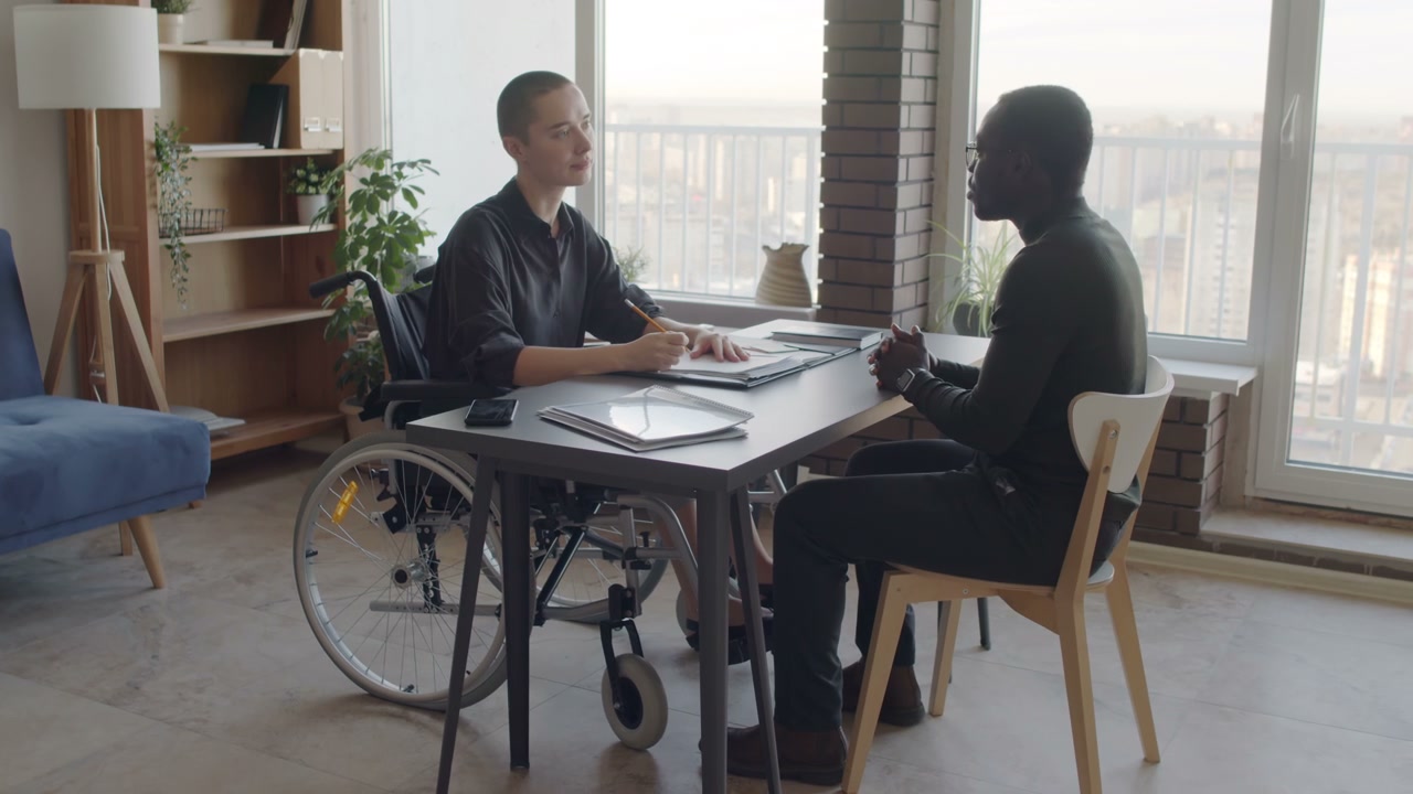 Woman in Wheelchair Interviewing Applicant