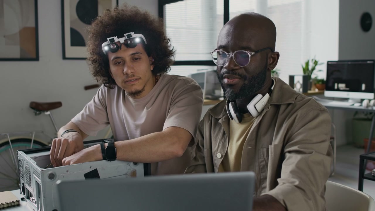 Two Developers Troubleshooting Computer
