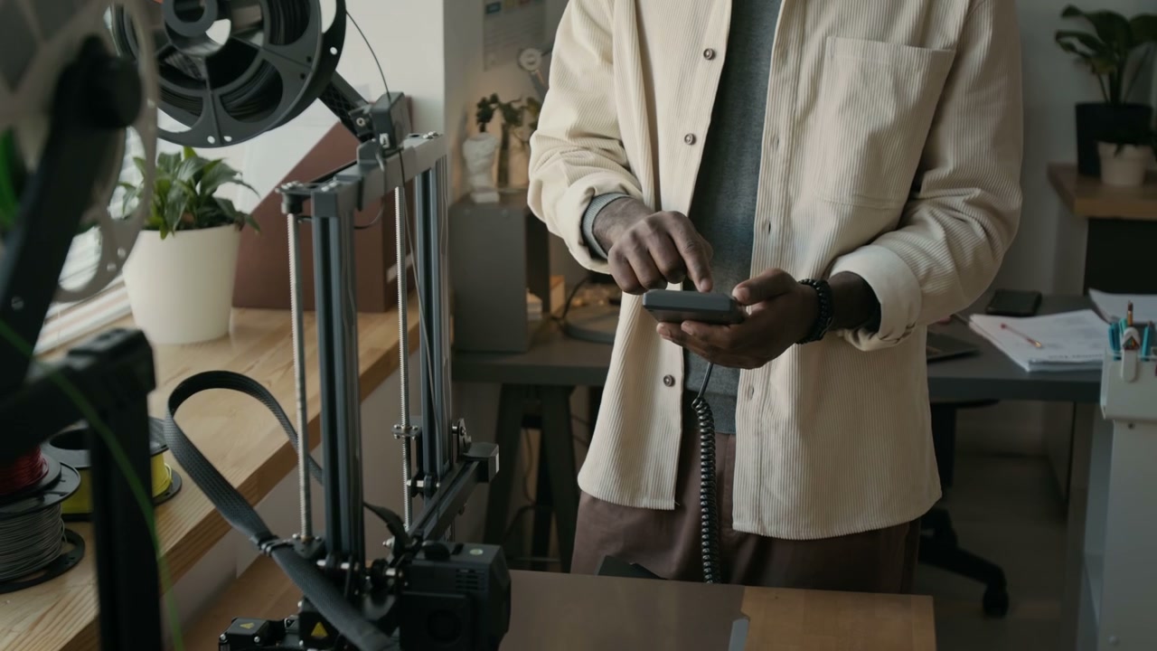 Person Operating 3D Printer