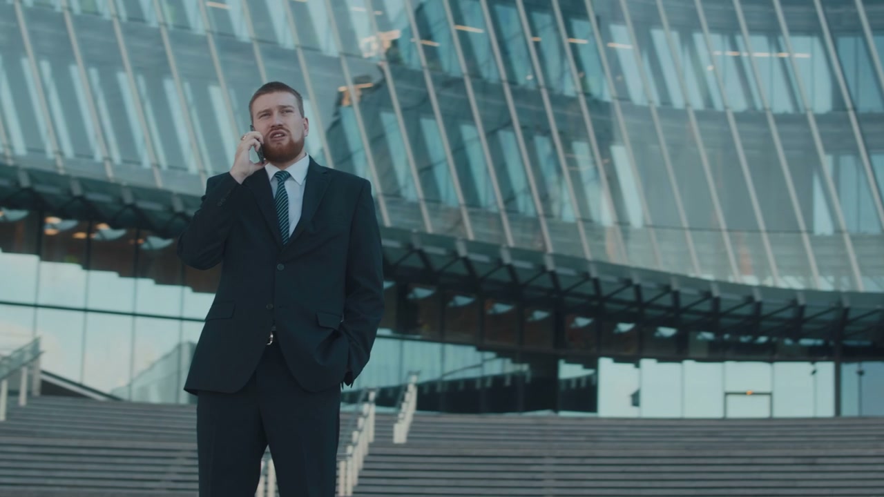 Businessman Talking on Smartphone Outside Office