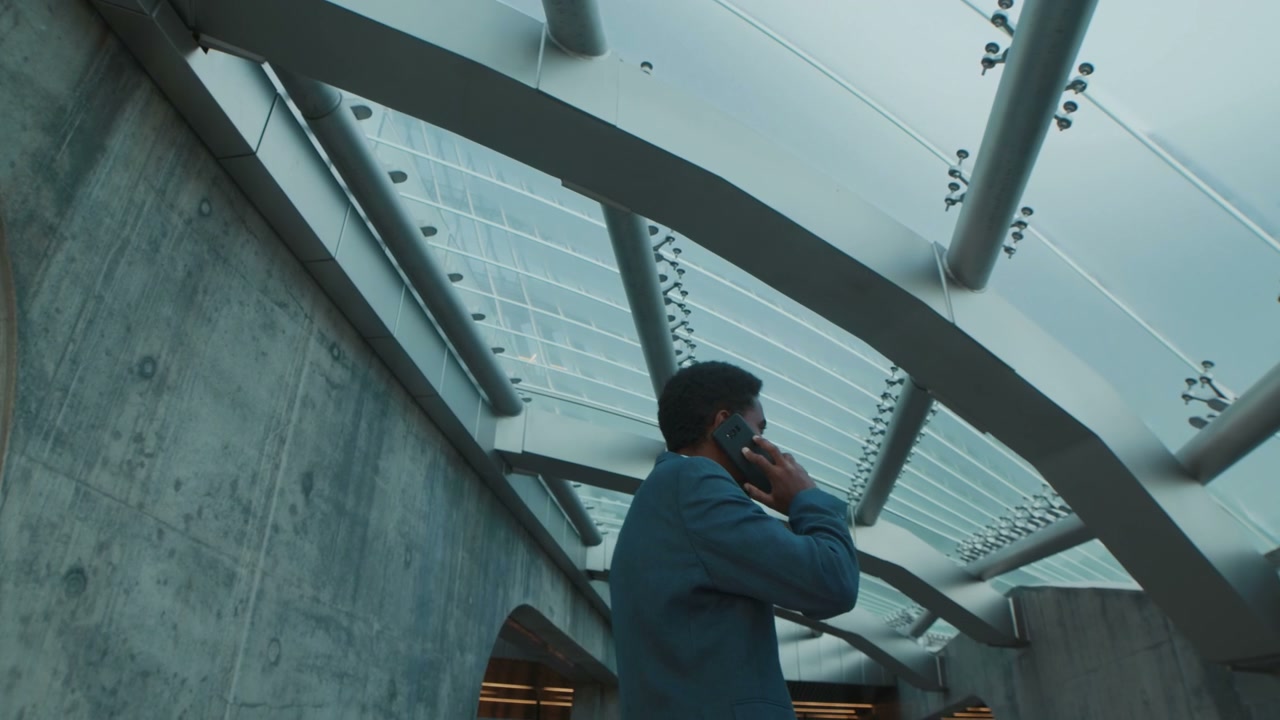 Businessman Talking on Phone in Modern Building