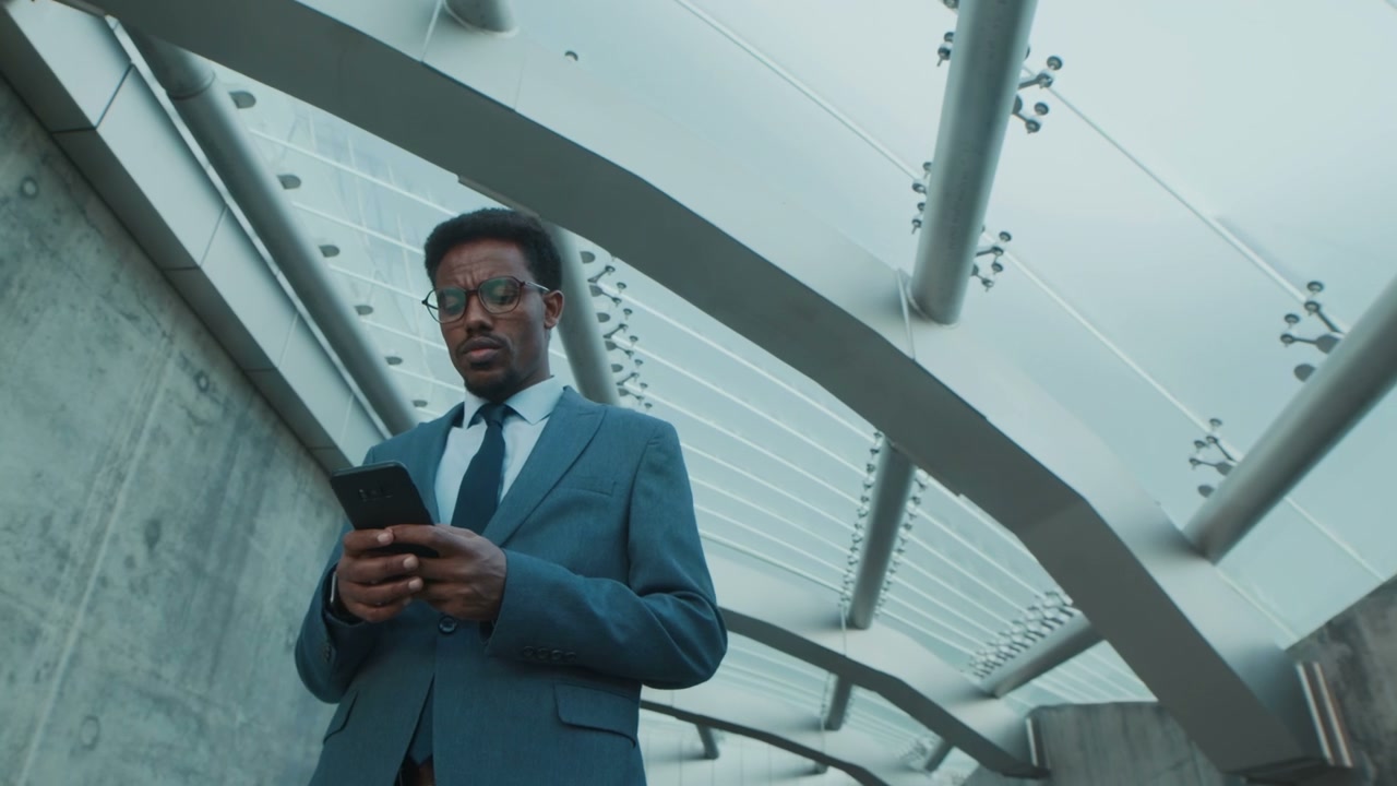 Businessman Checking Phone in Modern City