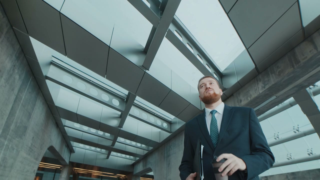 Confident Businessman Drinks Coffee in Modern City