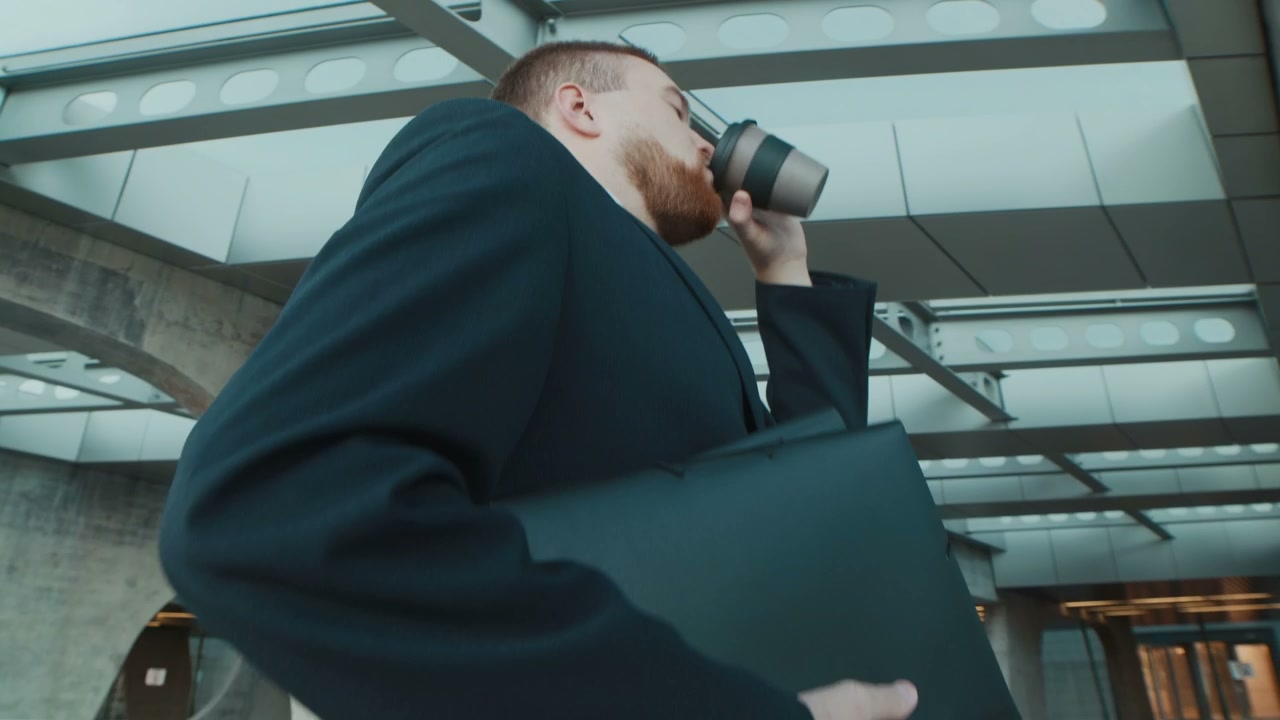 Professional Man Walking with Coffee and Documents