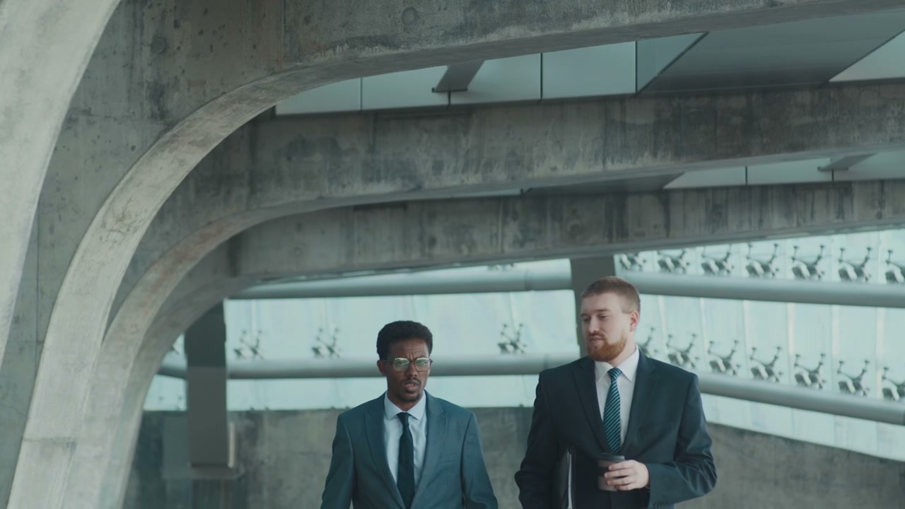 Businessmen Walking and Talking in a Modern City