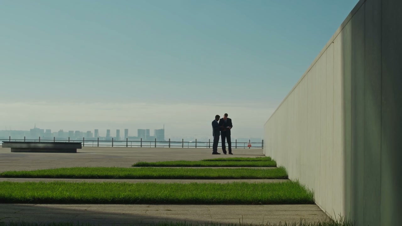 Two Businessmen Talking on City Plaza