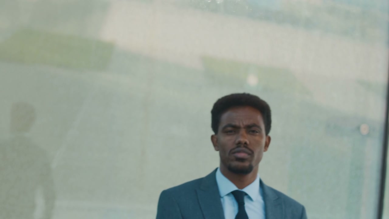 Confident Businessman Looks at Camera Outdoors