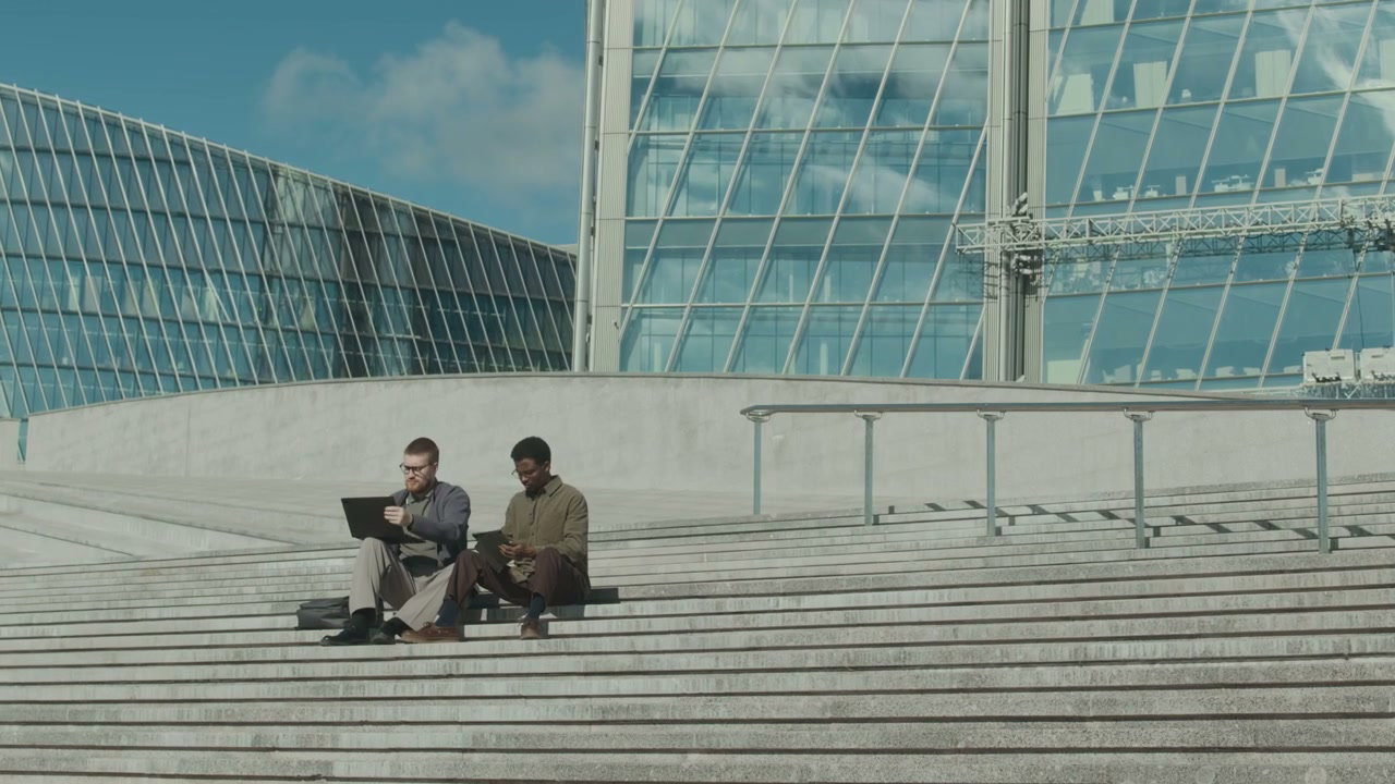Businessmen Working Outdoors on City Stairs