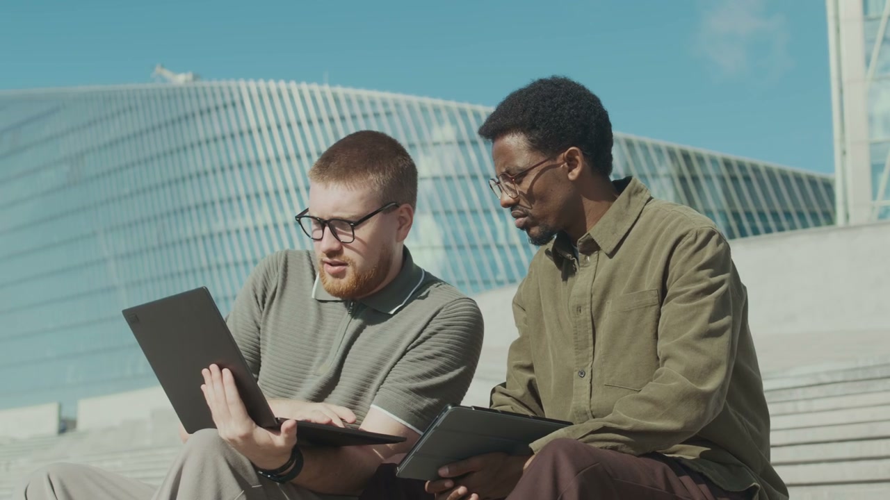 Two Men Collaborating on City Steps