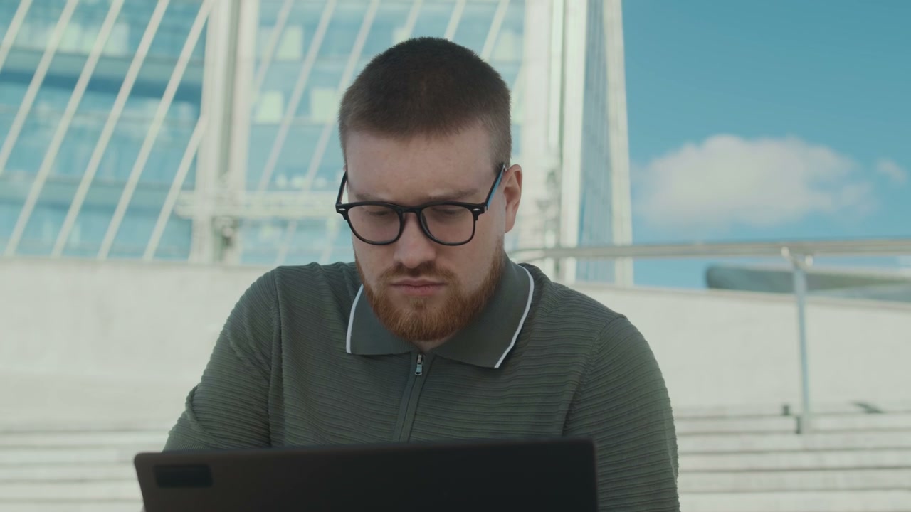 Man Working Outdoors Looks at Camera