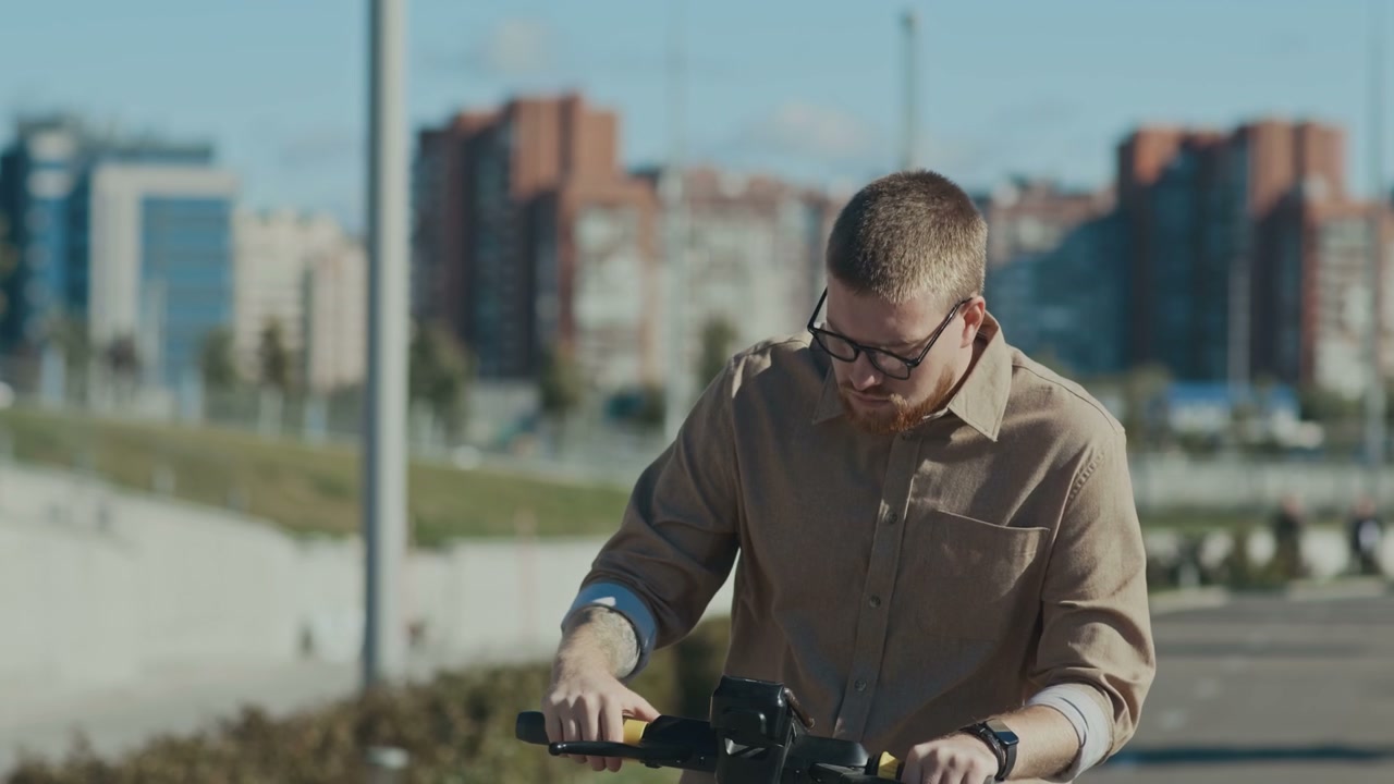 Man Operating Electric Scooter in Urban Park