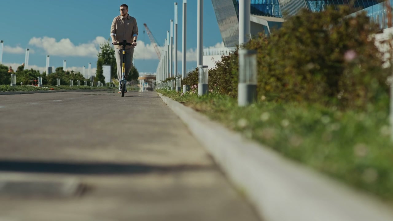 Man Riding Electric Scooter in Modern City