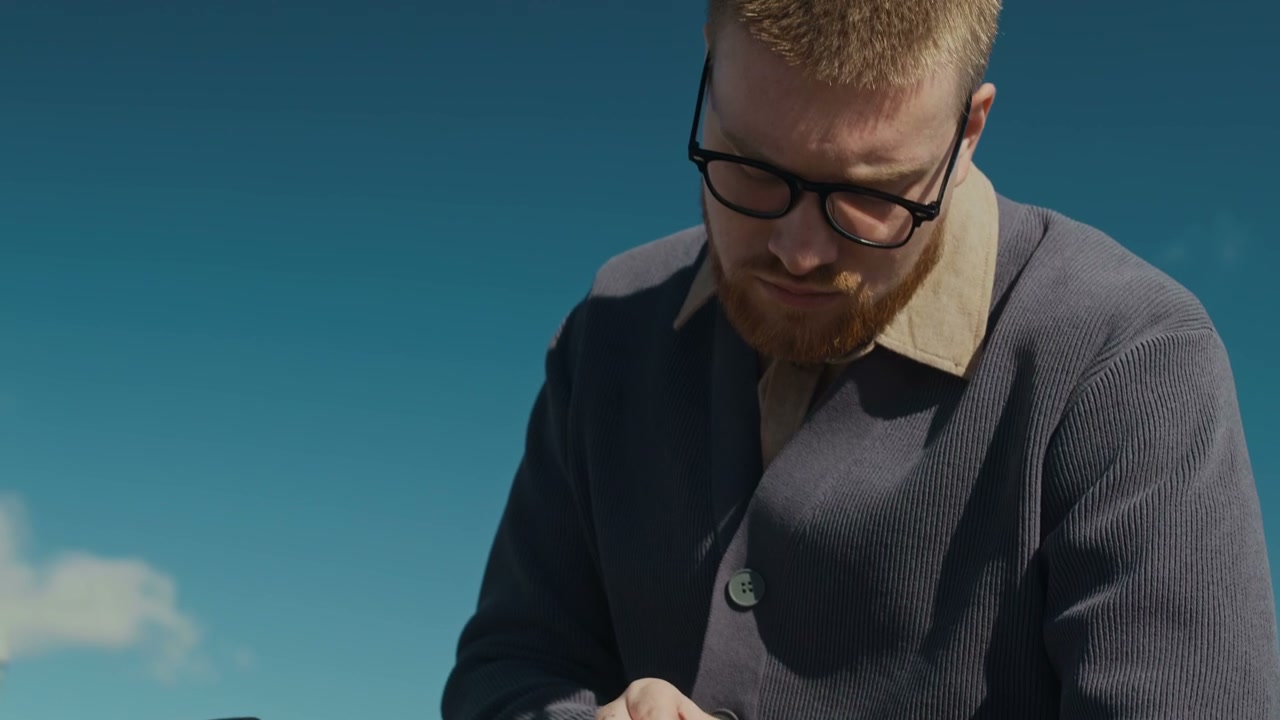 Man on Electric Scooter Checks Smartwatch