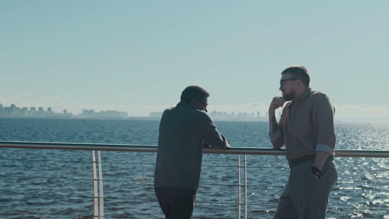 Two Men Talking by City Waterfront