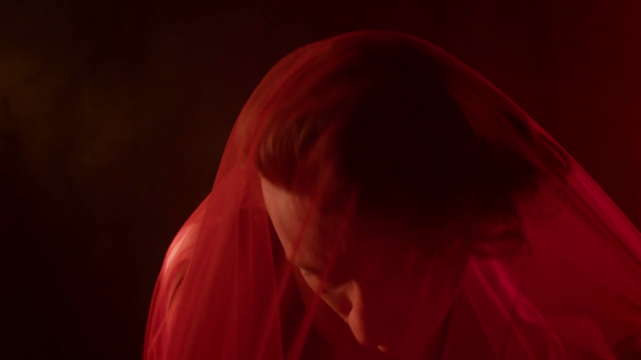 Dramatic Portrait of Man with Red Veil