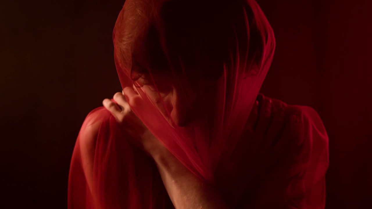 Pensive Man Under Red Veil