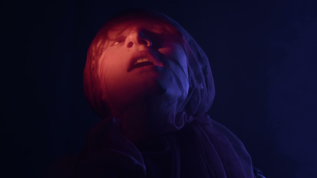 Man Struggling Under Red Veil