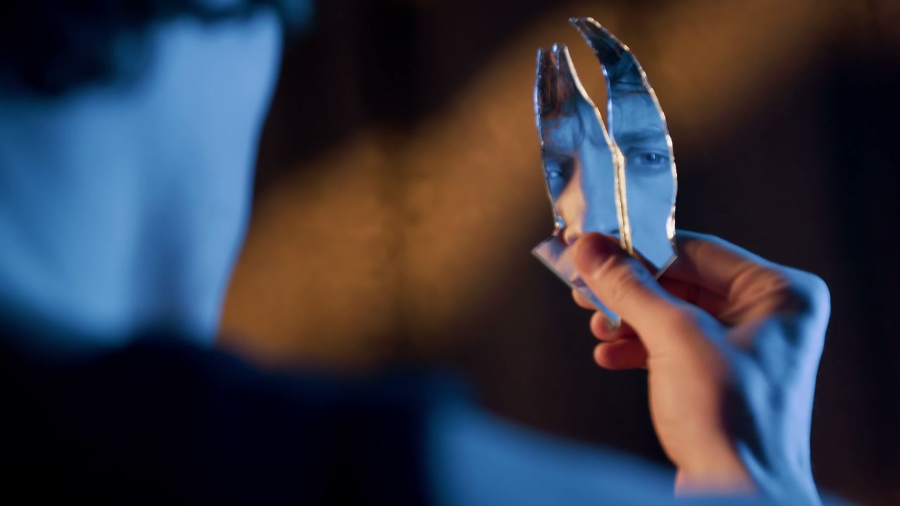 Man Holding Broken Mirror Reflecting Eye