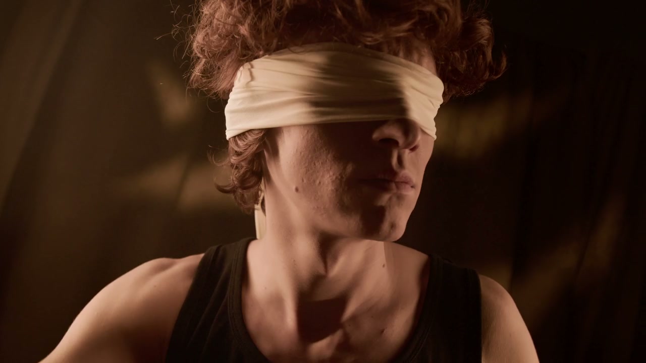 Blindfolded Man Searching in Darkness