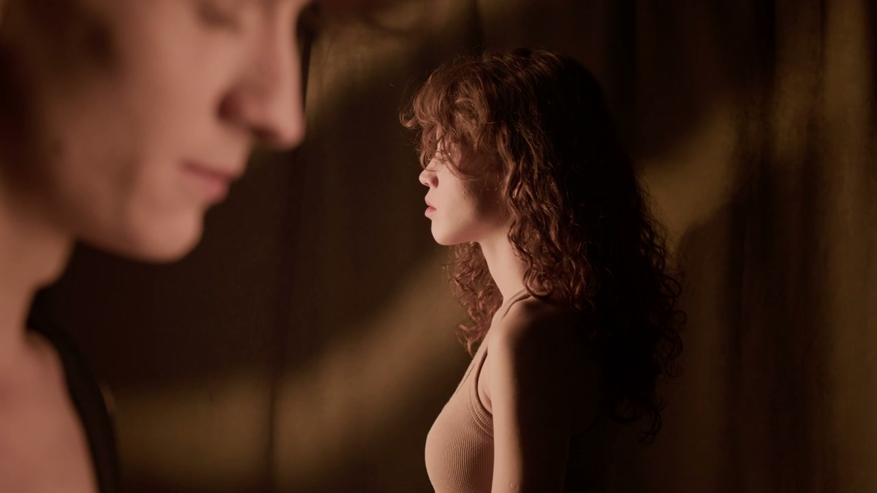 Melancholy Woman Looks Back At Camera