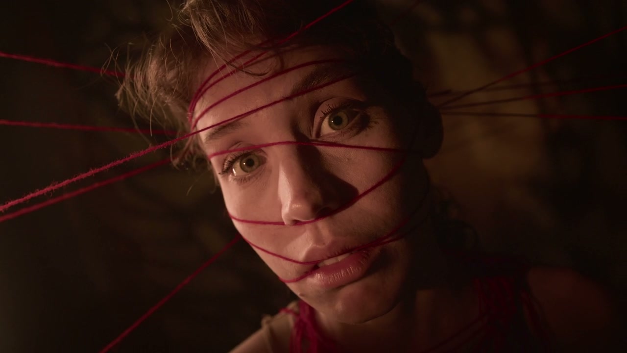 Distressed Woman Tangled in Red Threads
