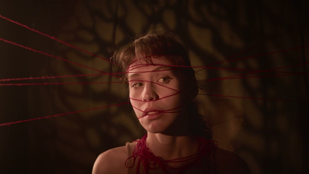 Young Woman Entangled in Red Threads