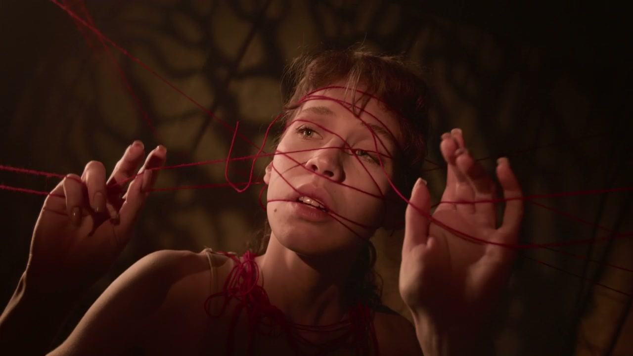 Anxious Woman Tangled in Red Threads