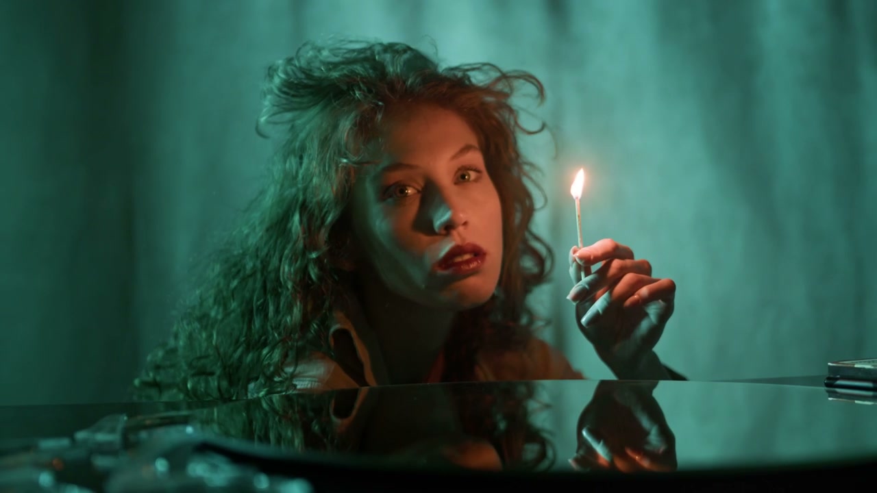 Pensive Woman Holding Lit Match in Studio