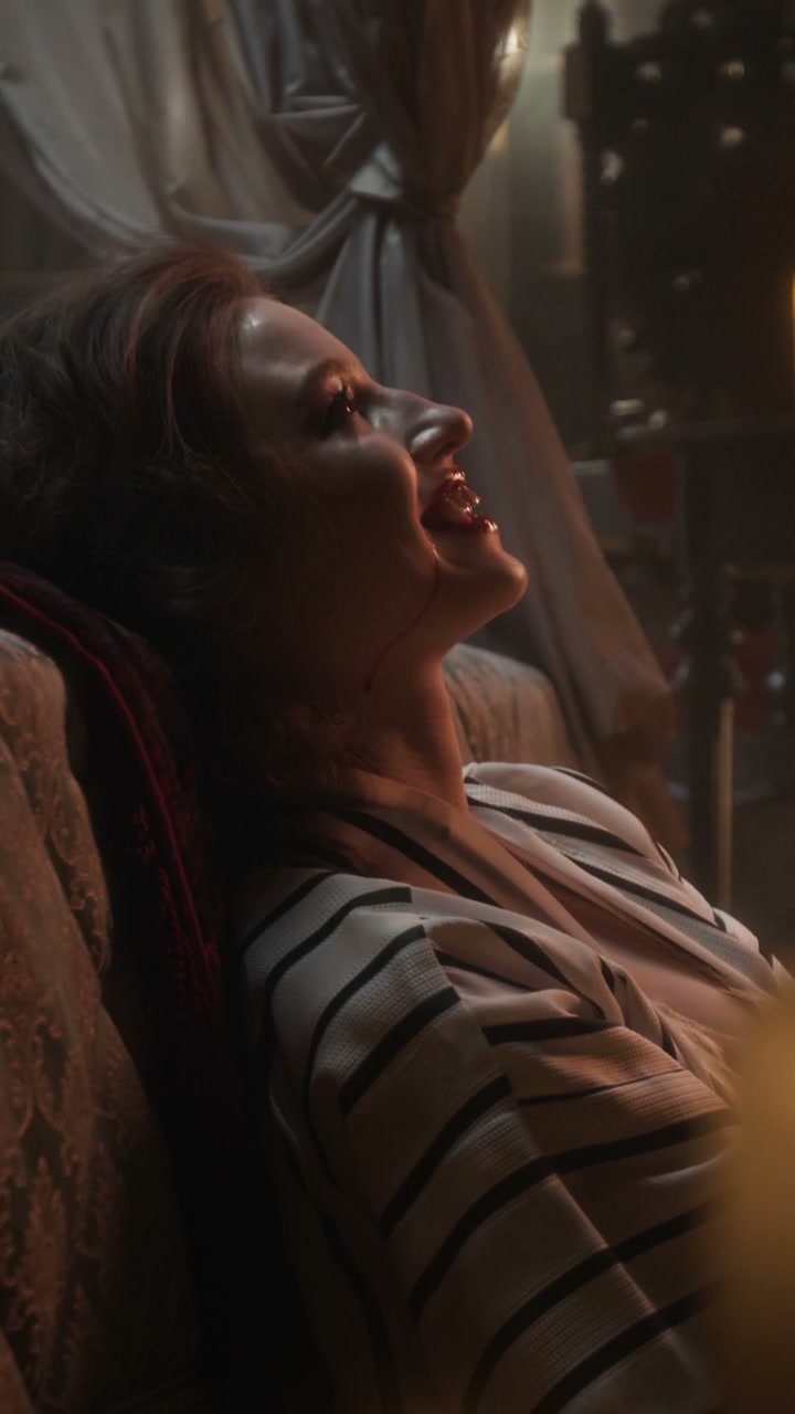 Seductive Vampire Woman with Blood and Fangs