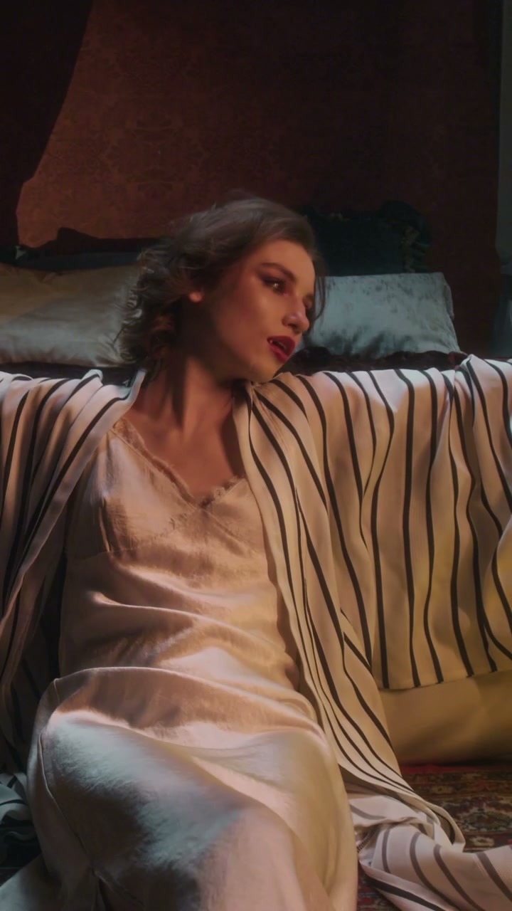Seductive Vampire Woman in Bedroom