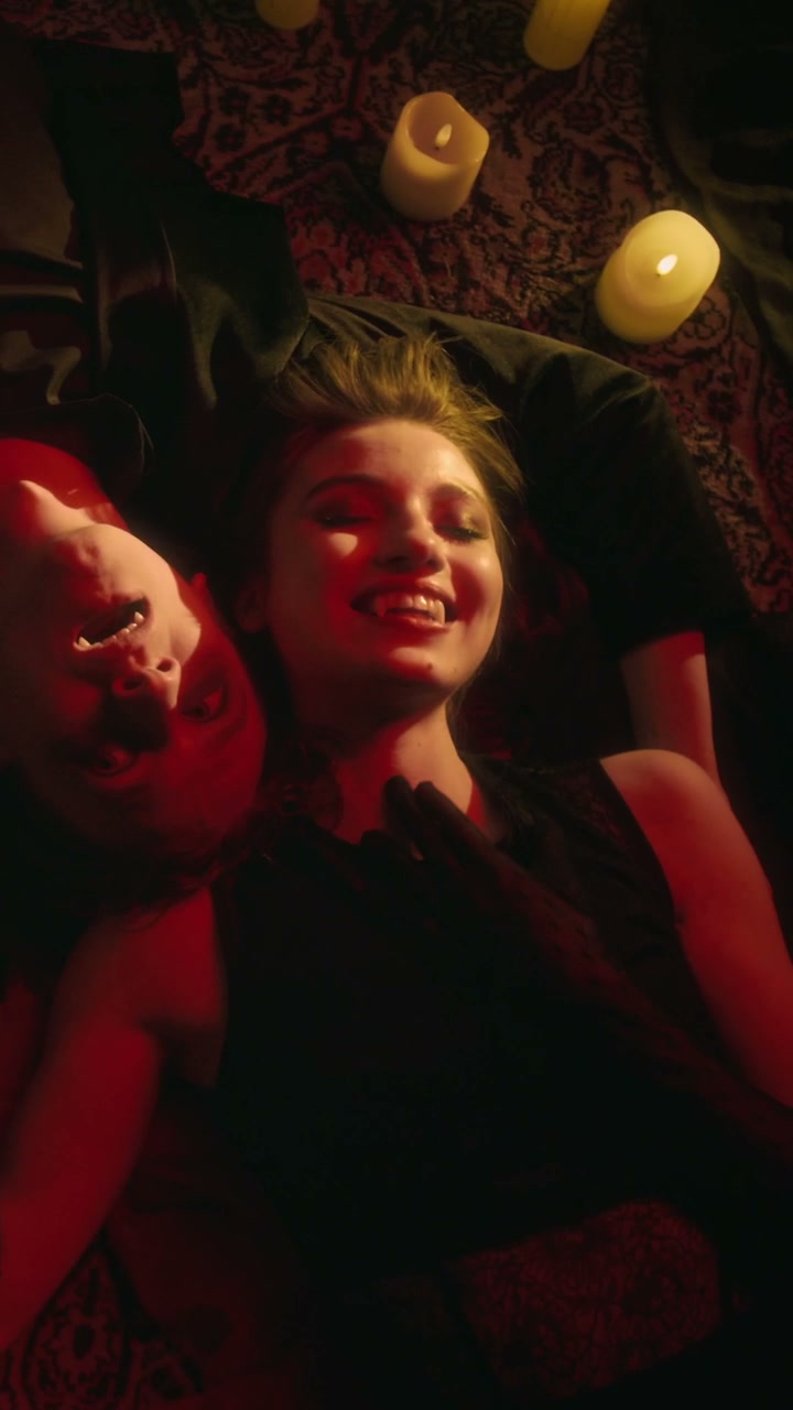 Gothic Vampire Couple Showing Fangs