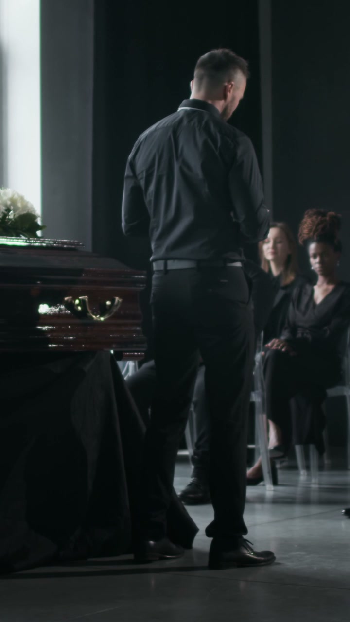 Man Speaking at a Funeral Service