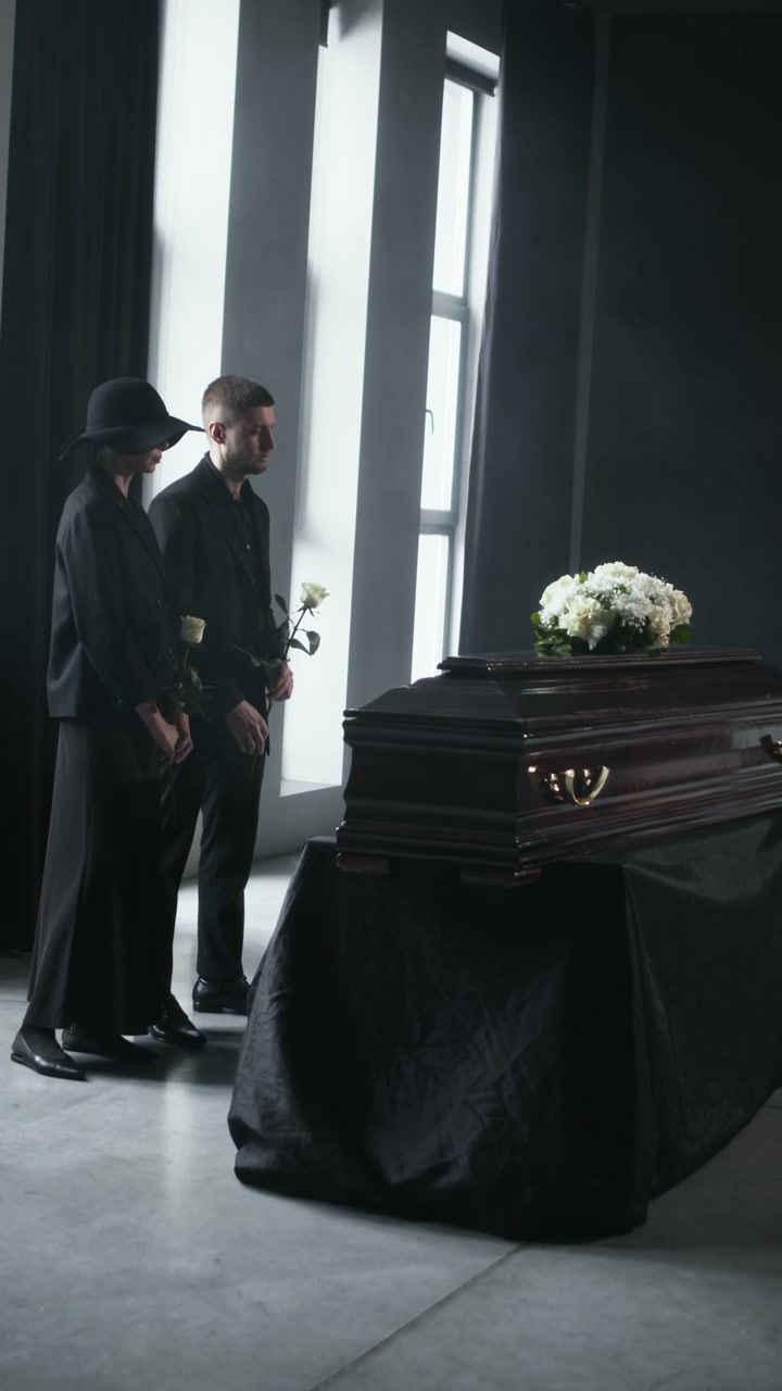 Mourners at Funeral Ceremony with Coffin