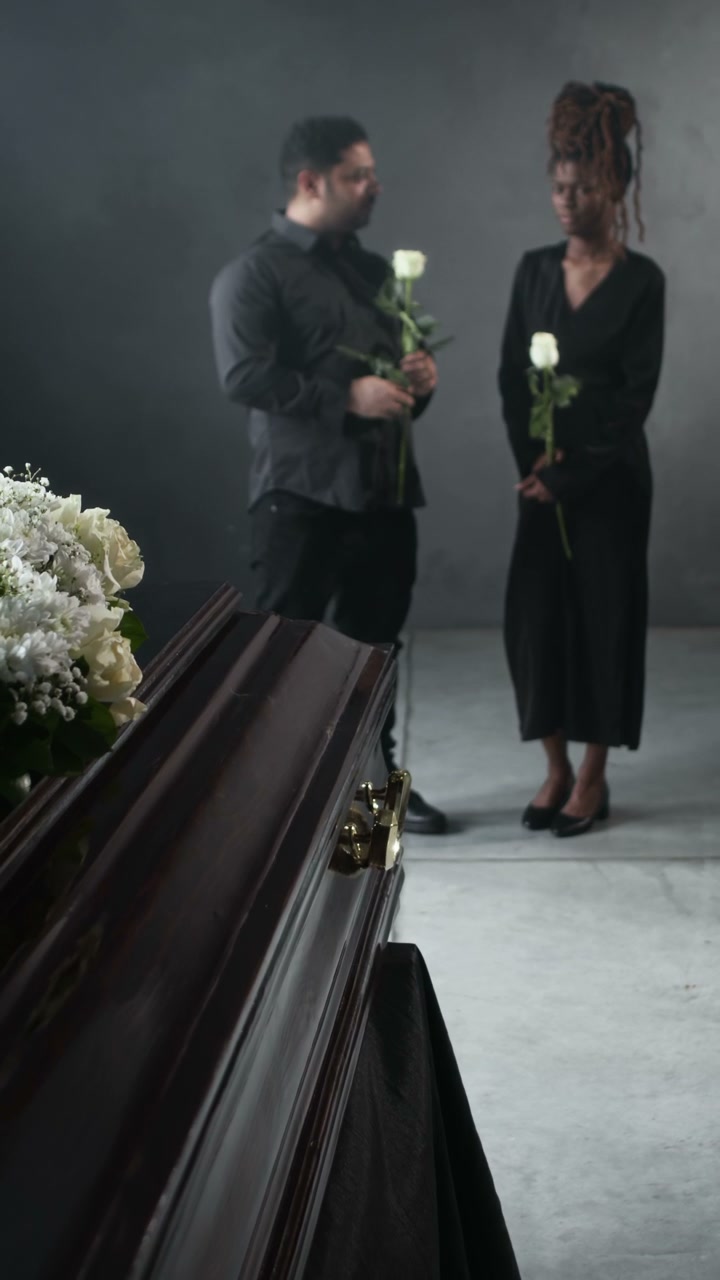 Mourners with Flowers at a Funeral