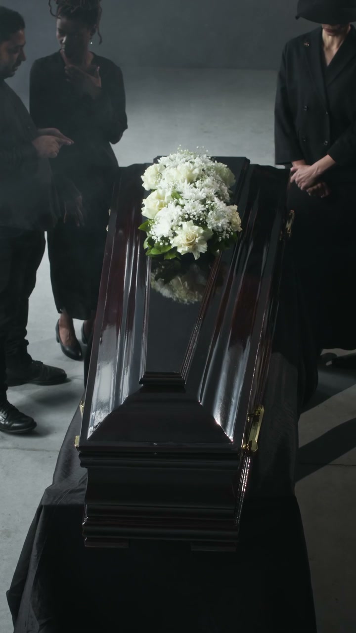 Mourners Standing Around a Coffin with Flowers