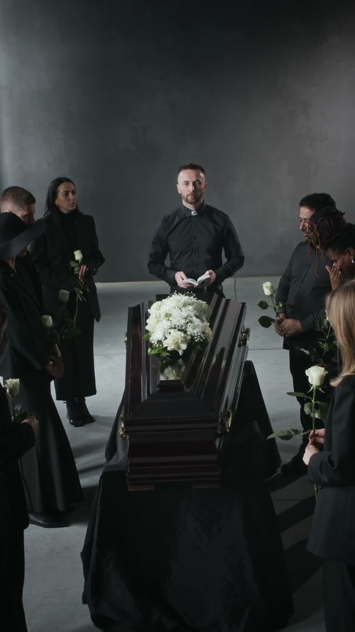 Mourners at Funeral Service with Priest
